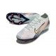Bota Nike Zoom Mercurial Vapor XVI Elite FG MDS Casi Verde Dorado metalizado Moneda